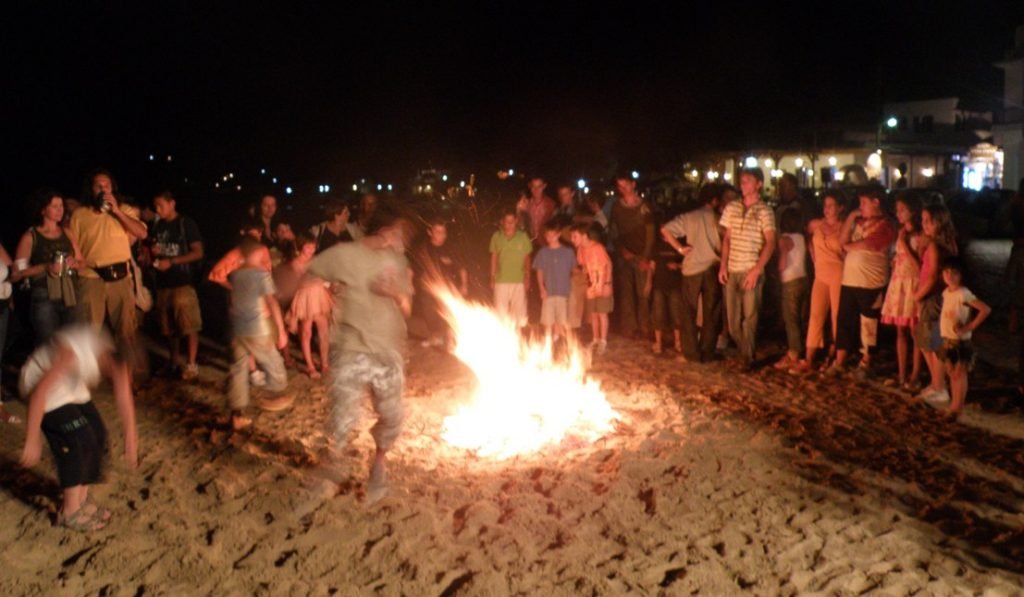 boys jumping bonfire